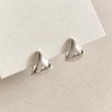 Triangle dome sterling silver hoop earrings with a bold, smooth surface that catches light effortlessly, blending modern simplicity with a sculptural, artful edge.