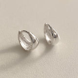 Thick modern hoop earrings in teardrop design