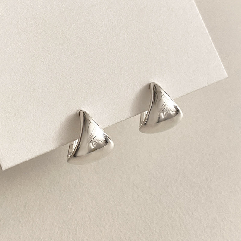 Triangle dome sterling silver hoop earrings with a bold, smooth surface that catches light effortlessly, blending modern simplicity with a sculptural, artful edge.