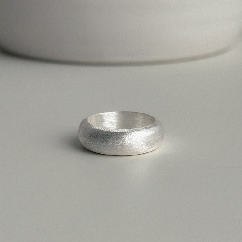 Chunky matte sterling silver band ring with a curved dome shape, perfect for modern fashion styling or worn solo as a statement accessory.