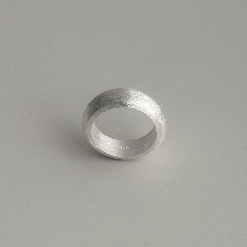 Unisex sterling silver dome ring featuring a bold profile and smooth matte surface, combining minimalism with architectural presence.