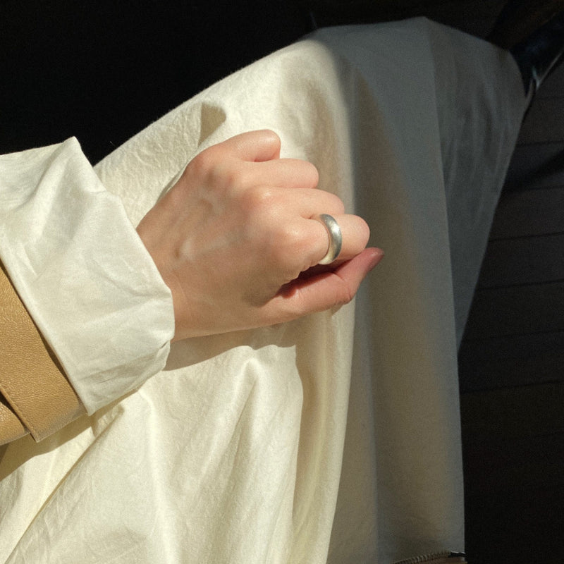 Matte silver wide band ring with a sculptural domed form, handcrafted from solid sterling silver for a classic, understated statement piece.
