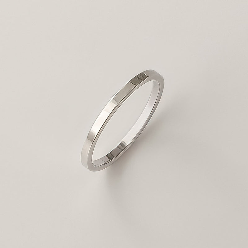 Thin silver band with a flat profile and smooth polish, made in sterling silver. A staple piece for minimalist styling or ring stacking.
