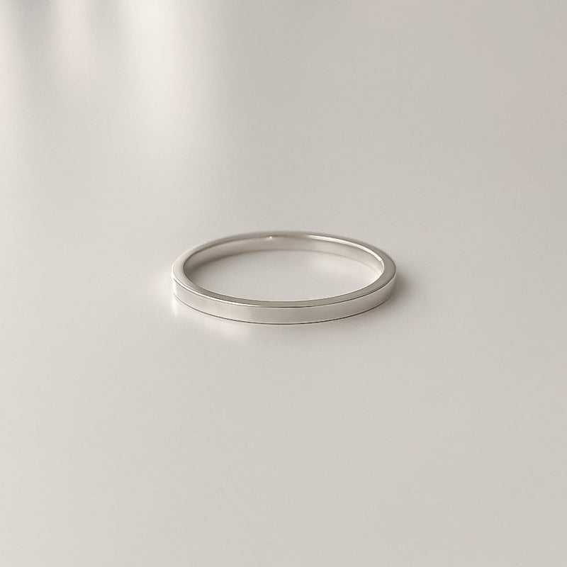 Polished sterling silver ring with a 1.5mm flat design. Ideal for stacking, layering, or wearing as a subtle everyday band.