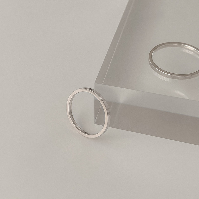 Sleek and refined sterling silver flat band ring measuring 1.5mm wide. Designed for stacking or subtle standalone wear.