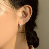Handcrafted sterling silver earrings featuring two rounded teardrop domes per hoop. The compact, chunky design delivers impact while maintaining everyday wearability. A perfect blend of volume, shine, and sculptural style.