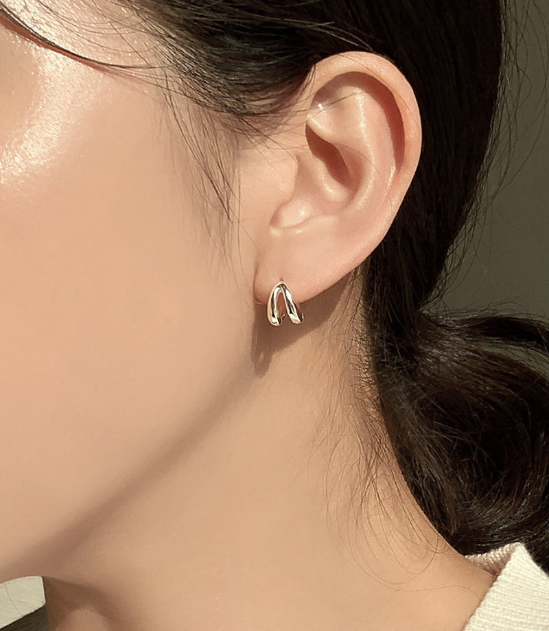 Delicate yet bold mini huggie hoop earrings designed with a double-line band, creating a refined contrast of structure and simplicity in a compact, elegant form that suits any occasion.