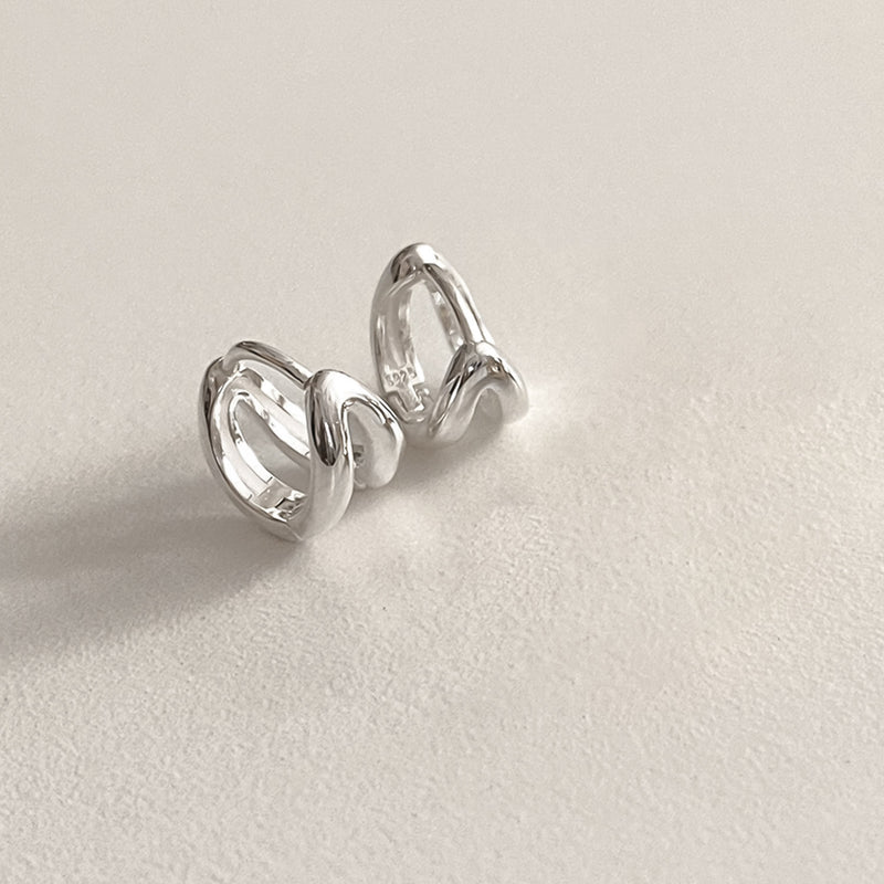 Contemporary double line huggie hoop earrings in a mini size, made from sterling silver and shaped to follow the natural curve of the ear, delivering comfort and style in one refined piece.