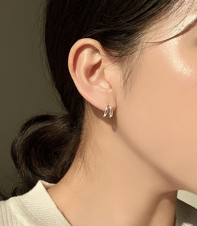 Sterling silver mini hoop earrings with a double-band design, crafted for a minimalist aesthetic with architectural flair — a versatile piece that blends into both day and night styling.