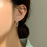 Elegant drop earrings crafted in solid sterling silver with two softly elongated oval links, offering a modern yet timeless design that swings gently and catches light with each step.