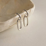 Contemporary chain link earrings in sterling silver, shaped into gently rounded ovals with a high-polish finish, offering a delicate yet distinct silhouette that flatters any outfit.

