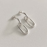 Oval link drop earrings made of sterling silver with a lightweight structure and sculptural design, ideal for adding a subtle yet sophisticated accent to everyday or formal wear.


