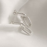 Polished sterling silver earrings featuring double oval chain links that create fluid movement and an elegant dangle effect, perfect for modern minimalists seeking effortless style.