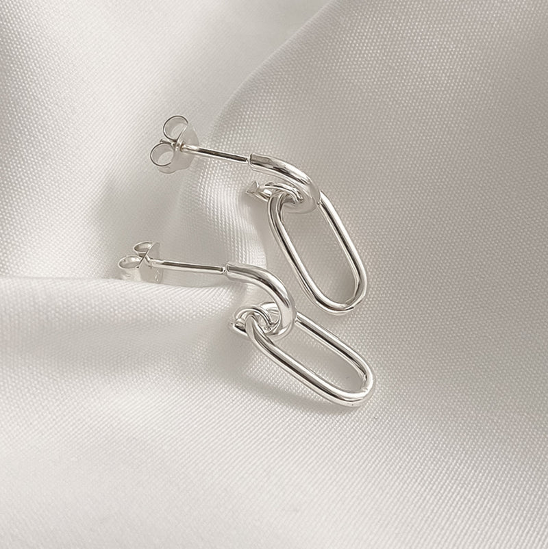 Polished sterling silver earrings featuring double oval chain links that create fluid movement and an elegant dangle effect, perfect for modern minimalists seeking effortless style.