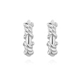 Sterling silver twisted rope huggie hoops with sculptural texture, classic design, and timeless elegance for versatile everyday wear.