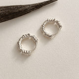 Chunky rope huggie earrings in sterling silver, featuring polished curves and twisted detailing for a modern yet vintage-inspired aesthetic.
