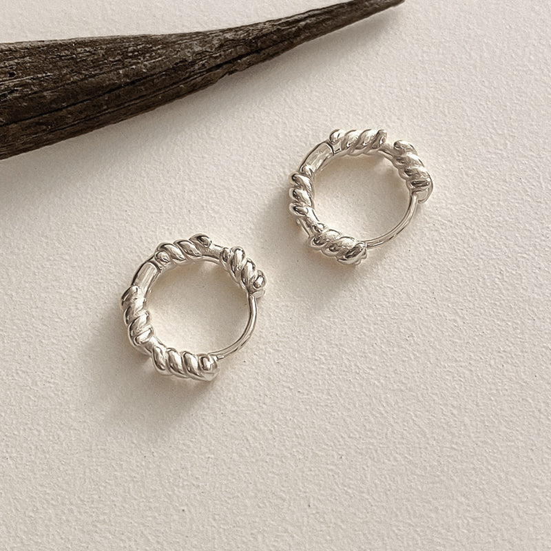 Chunky rope huggie earrings in sterling silver, featuring polished curves and twisted detailing for a modern yet vintage-inspired aesthetic.
