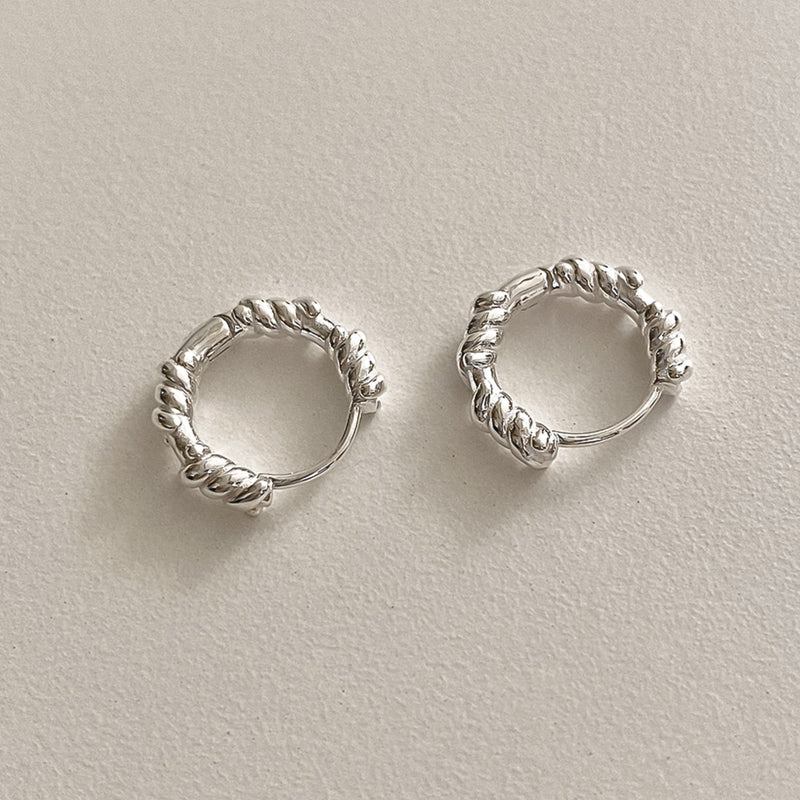 Handcrafted sterling silver rope hoop earrings with sculptural twist texture, modern minimalist style, and everyday versatility.