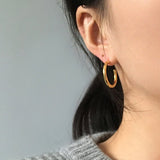 Classic gold hoop earrings for women, featuring a sleek and polished design with a smooth, rounded finish.